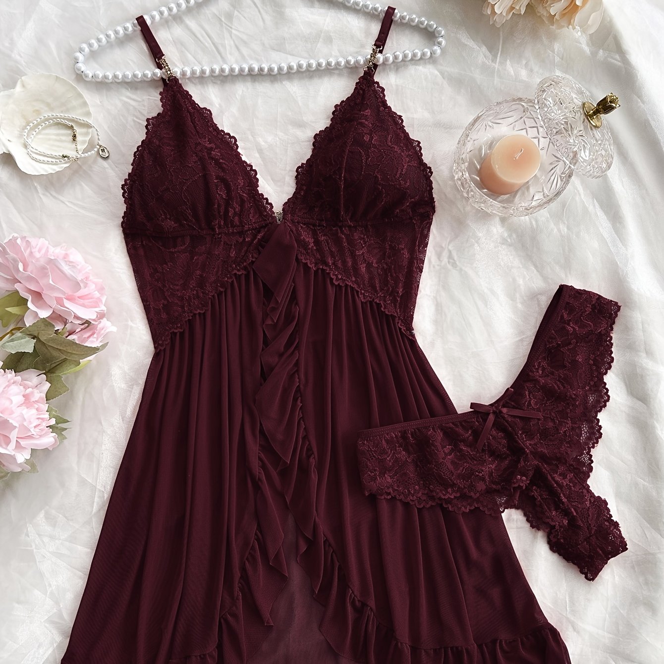 Stylish lace slip dress pajama set with V-neck, backless design, ruffle hem, and shorts. Made of breathable polyester blend, suitable for all seasons.