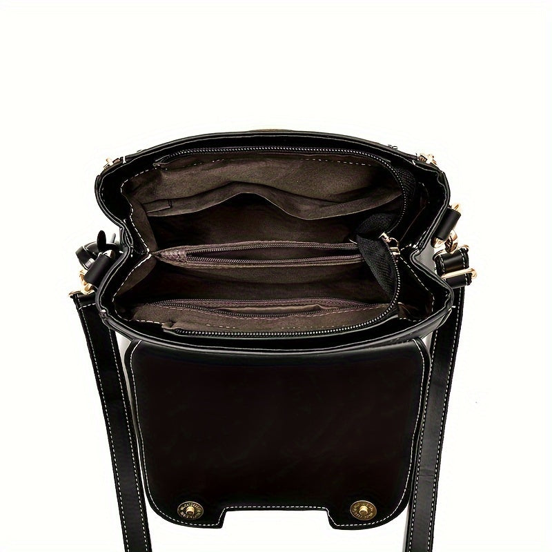 Rang kontrasti, tokalar bilan bezatilgan va nafis yuqori tutqichi bo'lgan zamonaviy sumka.