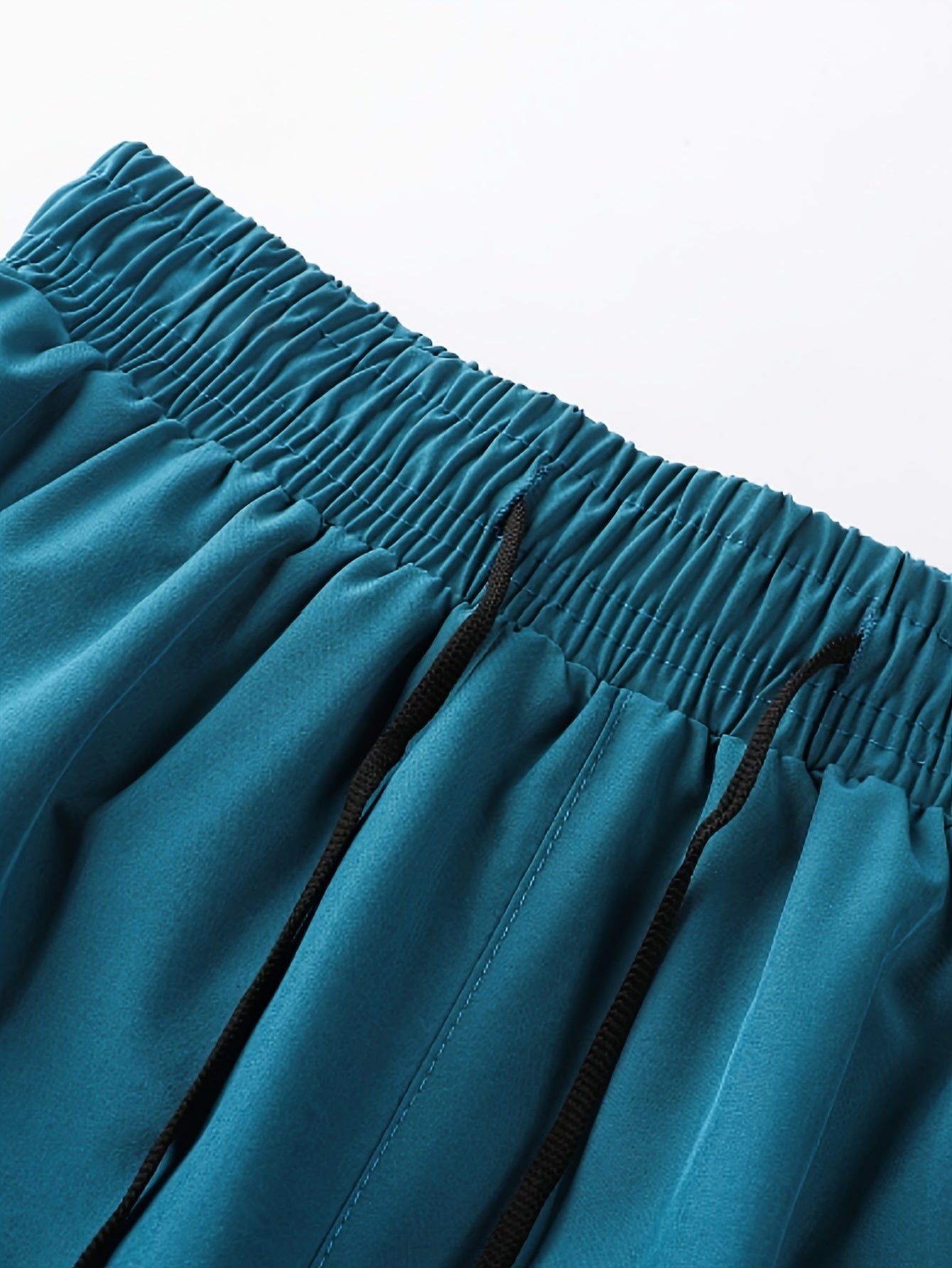 Erkaklar uchun ichki qismi bo'lgan tez quriydigan sport shortlari yengil, nafas oladigan va cho'ziluvchan, mashinada yuvish mumkin bo'lgan polyester aralashmasidan tayyorlangan.