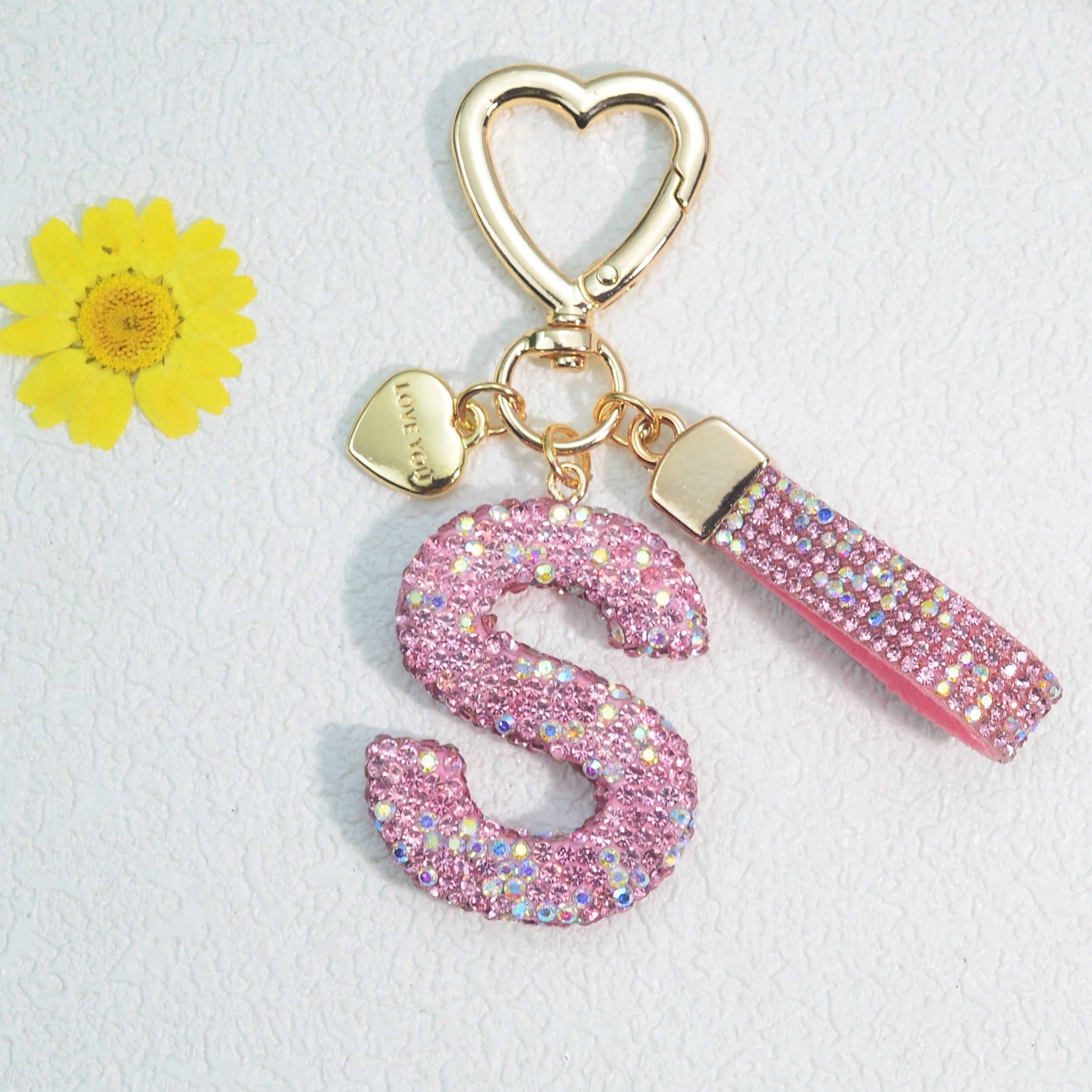 Llavero de PVC con iniciales de pedrería rosa y blanca con cierre de puño para mujeres