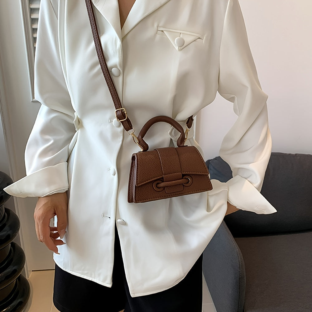 Zamonaviy niş dizayni, yuqori tutqichi va kvadrat shakli bilan uslubiy mini crossbody sumka.