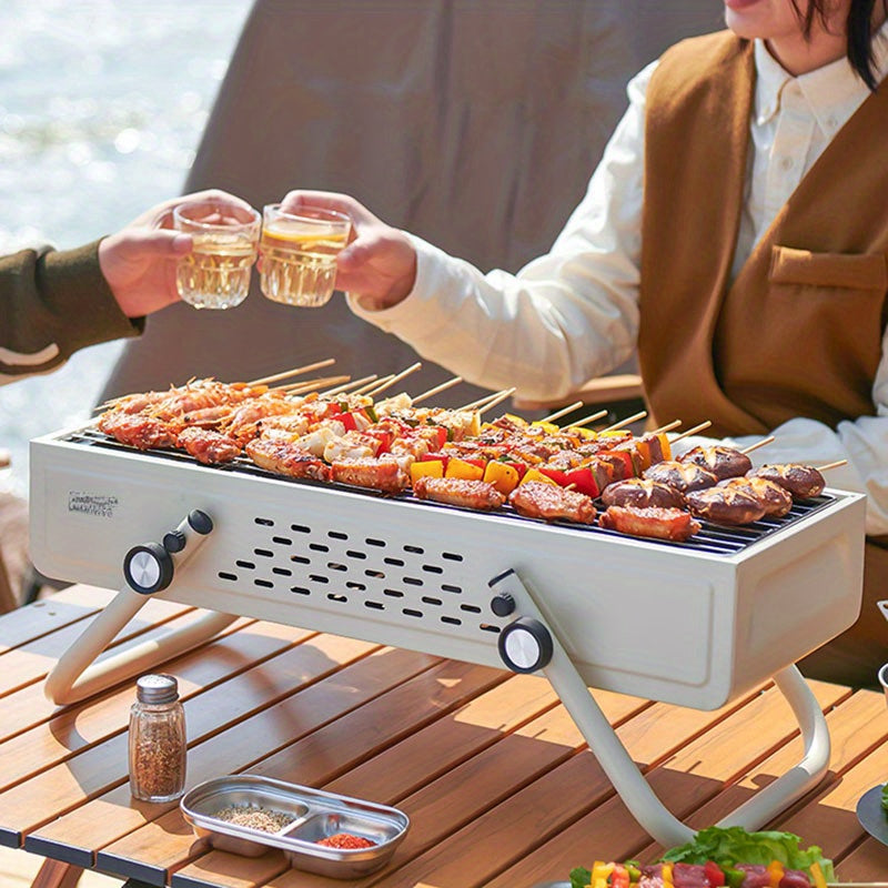 Tashqarida foydalanish uchun ideal portativ burilishli ko'mirli barbekyu grill.