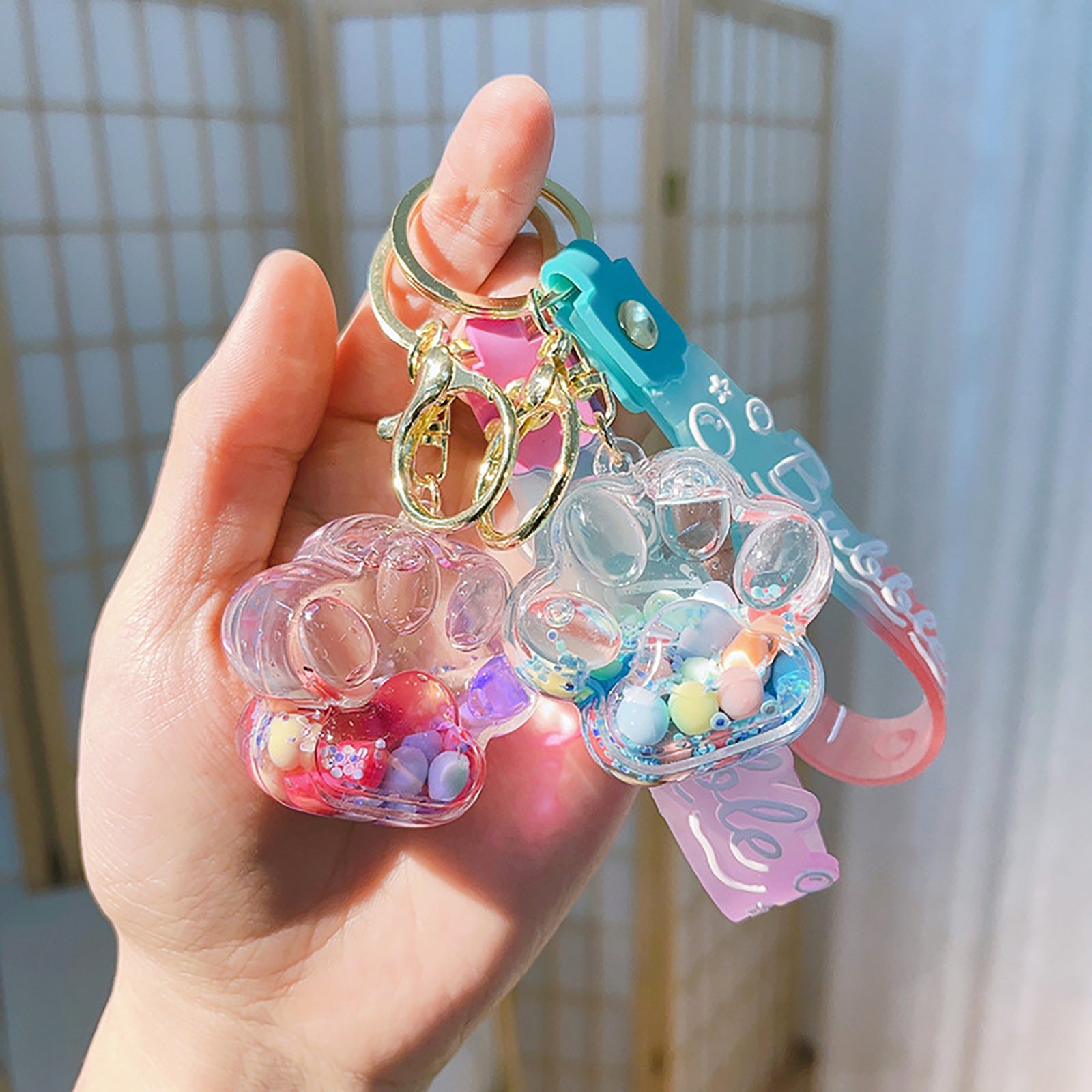 Llavero de pata de gato adorable con colgante de piruleta de gelatina flotante de arena movediza para bolsos y mochilas