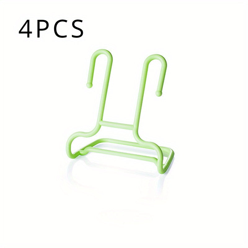 Juego de cuatro estantes de plástico para zapatos montados en la pared para almacenamiento y secado de niños