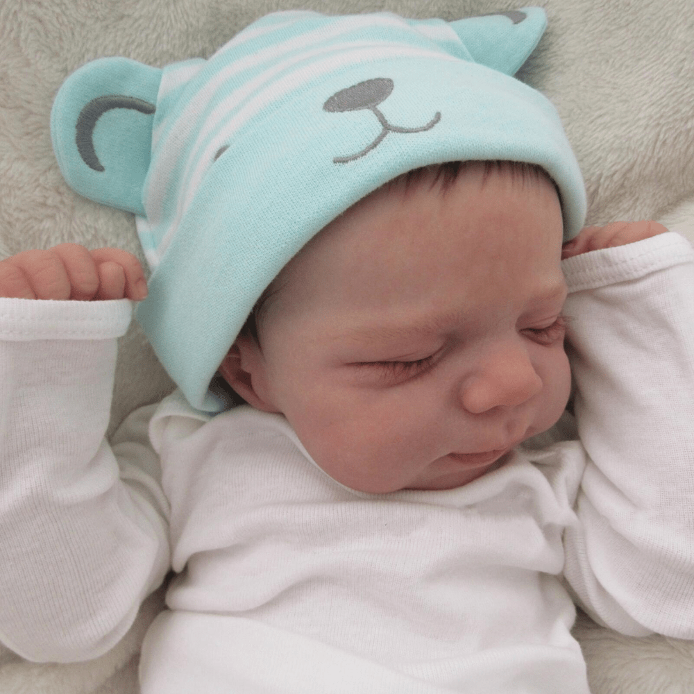18-Inch Reborn Girl Doll with Blue Bear Hat Soft Vinyl Lifelike Sleeping Pose for Children 3+