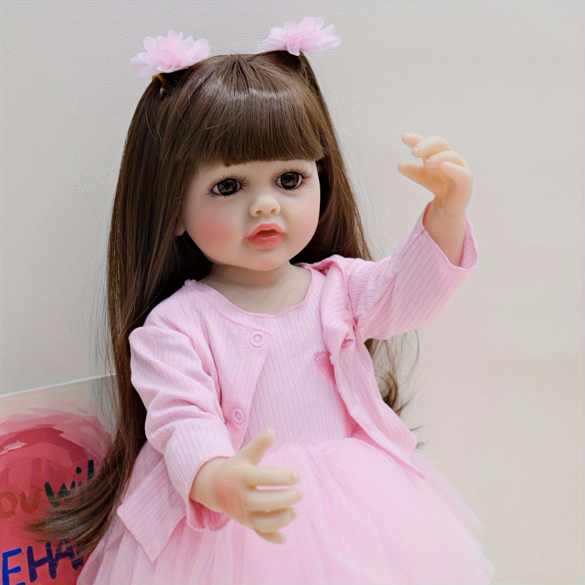 22-Inch Pink Reborn Baby Doll with Long Hair Wig Fully Poseable for Play and Collectors