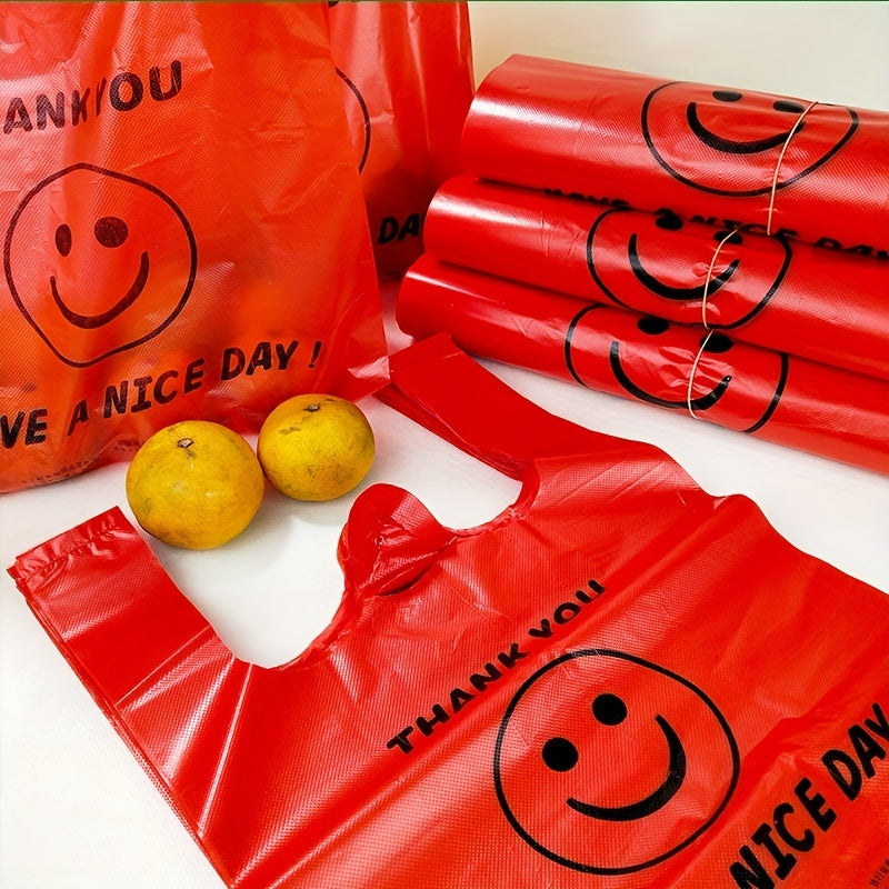 Paquete de 50 bolsas de plástico rojas para camisetas con diseño de rostro alegre, reutilizables y resistentes