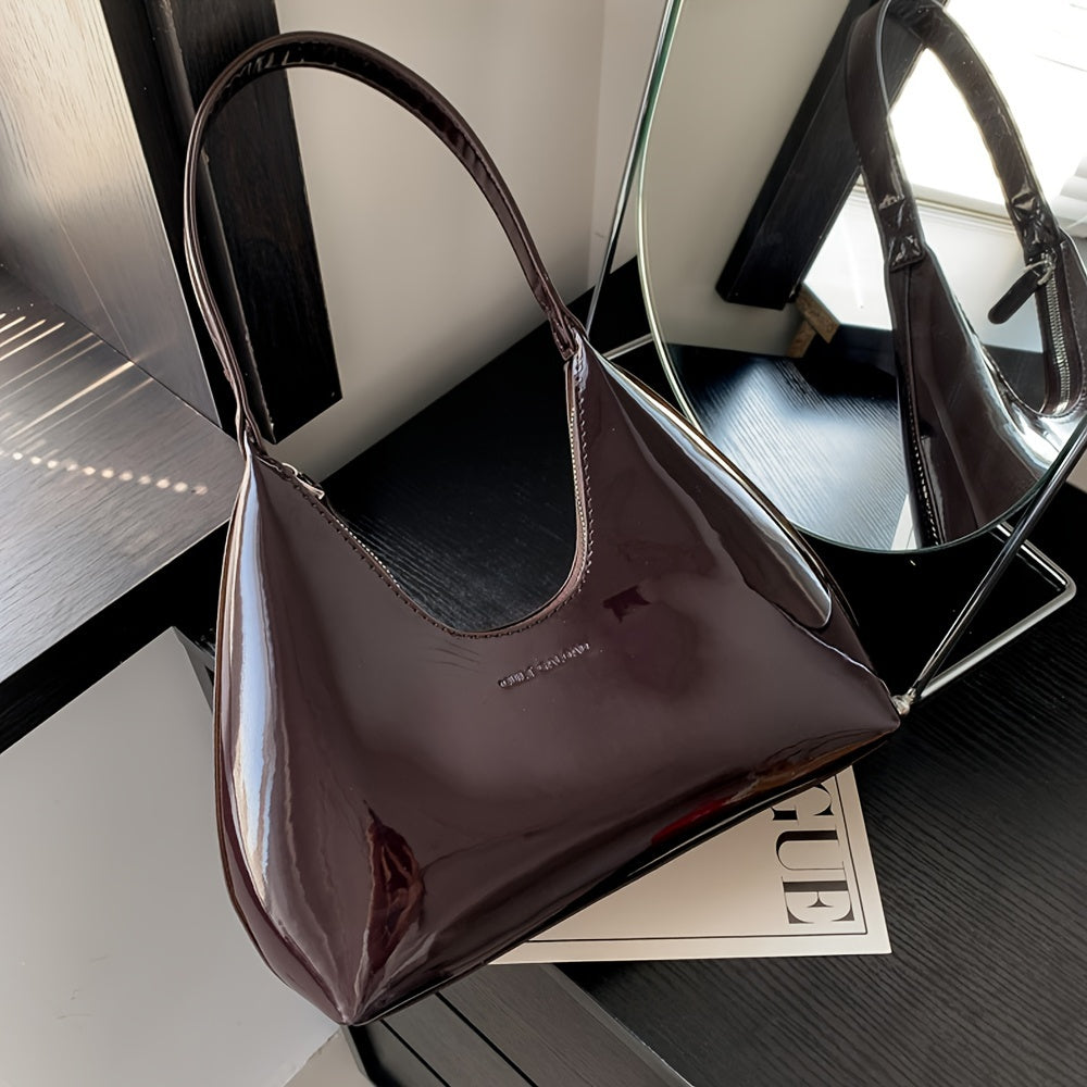 Шикарная красная сумка через плечо с глянцевой лакированной отделкой и застежкой на молнии, идеально подходящая для повседневного использования.