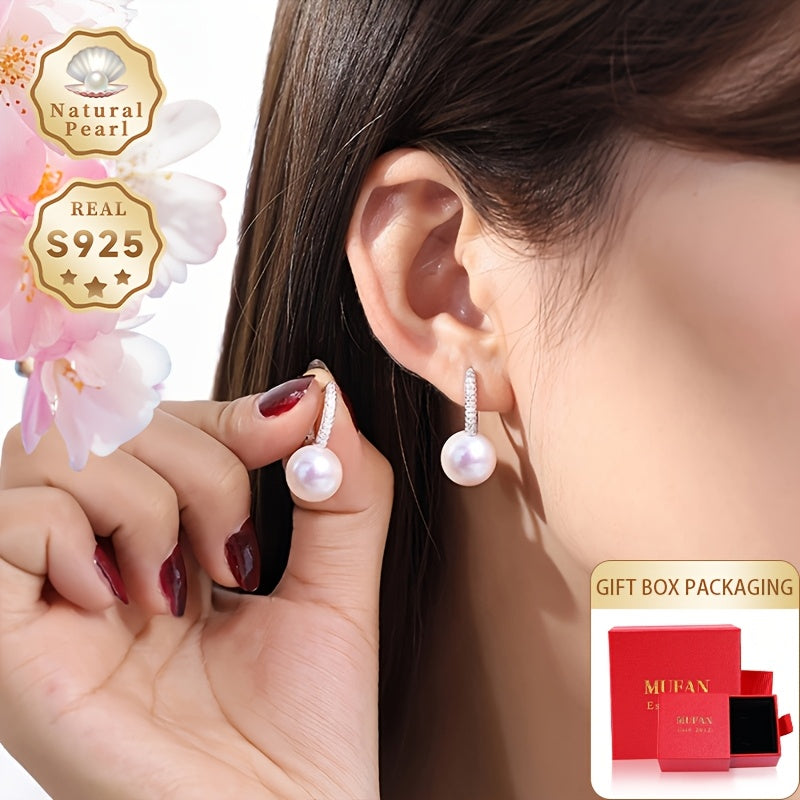 Zargarlik to'plamingizni zamonaviy va abadiy MUFAN Elegant Vintage Style Freshwater Pearl Drop Earrings bilan yangilang. Ushbu ajoyib sirg'alar katta 10-11mm dumaloq tabiiy toshlardan iborat bo'lib, S925 sterling kumush postlardan osilgan. Mukammal uchun
