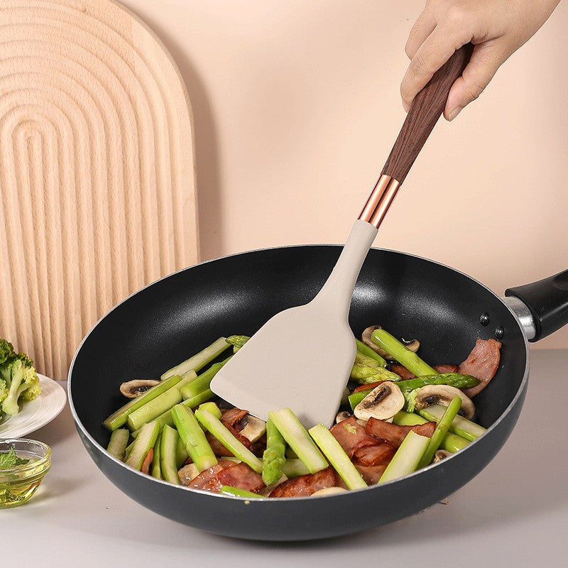 Silicone yog'och to'qimalari spatula, yopishmaydigan qoplama va issiqqa chidamli tutqich bilan, uyda pishirish uchun zarur bo'lgan oshxona asbobi