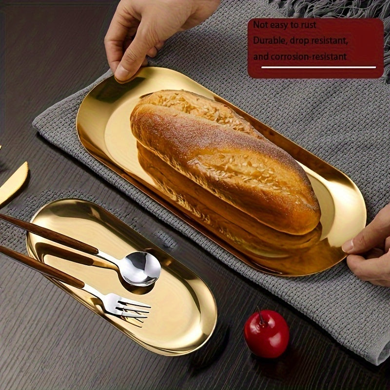 Oltin qoplamali zanglamas po'latdan yasalgan oval lagan - Minimalist dizayn, mustahkam va tozalash oson. Non, shirinliklar va atıştırmalıklarni zamonaviy stol bezaklarida xizmat ko'rsatish uchun ideal.