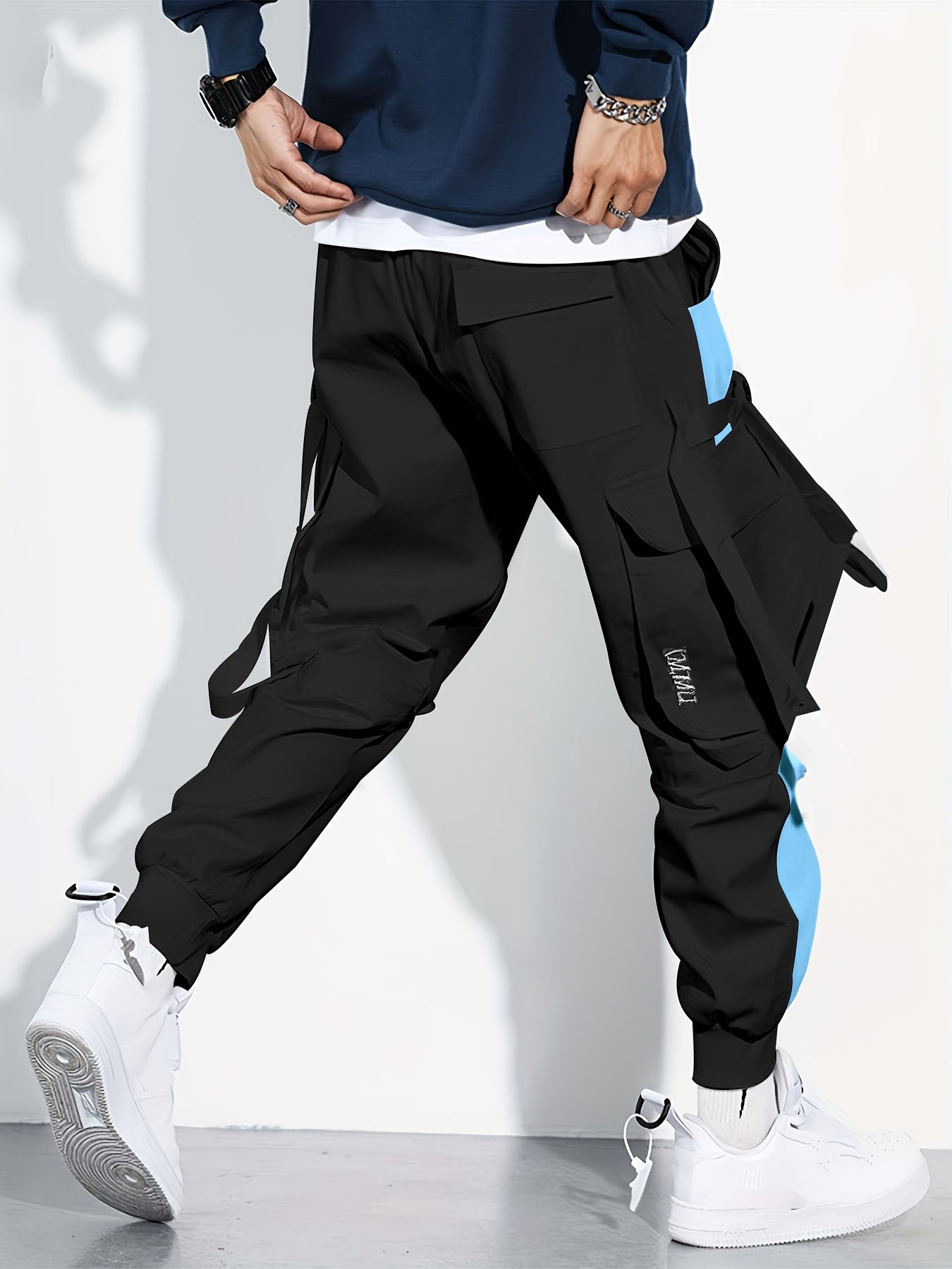 Erkaklar uchun zamonaviy, havo o'tkazuvchi rangli blokli kombinezonlar, ko'p cho'ntakli lenta dizayni bilan. Yoz va yugurish uchun ideal.