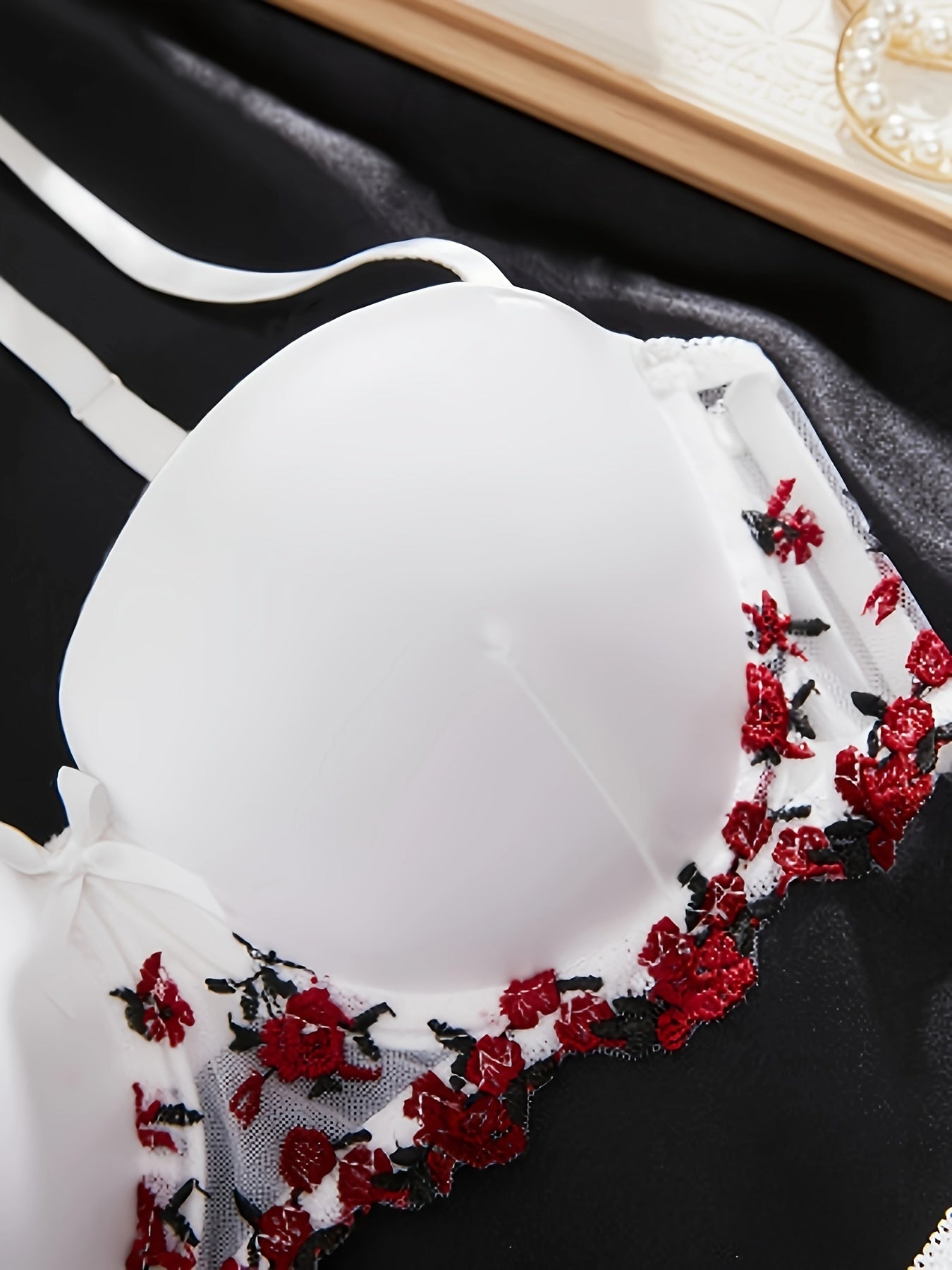 Yumshoq va qulay oq gullar bilan bezatilgan ichki kiyim, ko'krak yostiqlari bilan.