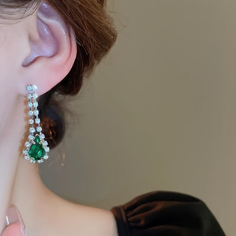 Элегантно выполненный в винтажном стиле капельных кисточек, этот набор включает роскошное зеленое ожерелье с rhinestones и подходящие серьги. Сделаны на медной основе и покрыты 18-каратным золотом, серьги имеют серебряные штифты 925 пробы для изящества.