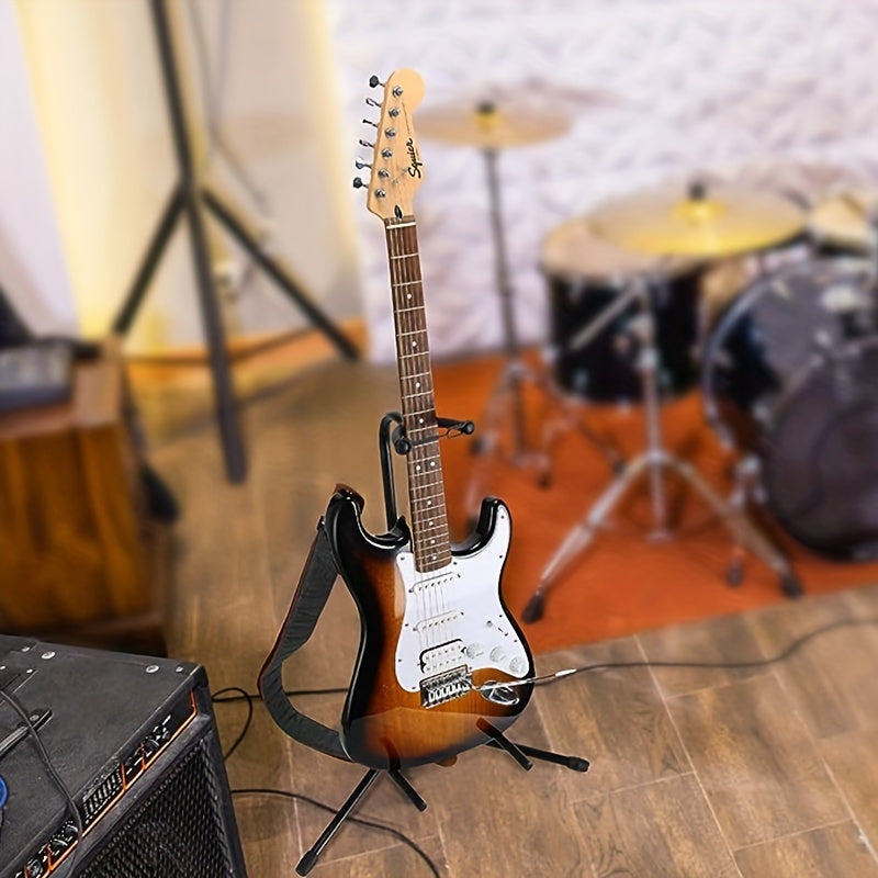 Barcha gitara turlari uchun yumshoq yostiq va rezina oyoqlarga ega sozlanadigan, bukadigan po'lat gitara stendi