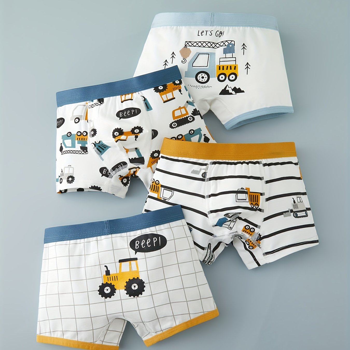 Yigitlar uchun paxta boxerlar to'plami 4 ta, ko'k va oq ranglarda multfilm ekskavator va transport vositalari naqshlari bilan
