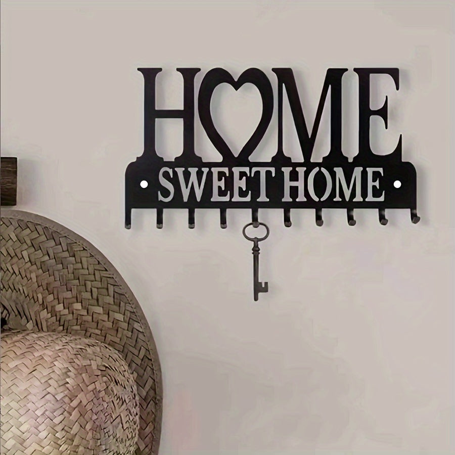 Qora metall devor qulfini tashkil etuvchi, kiyimlar, shlyapalar va kirish joyi uchun bezakli tutqichlar bilan