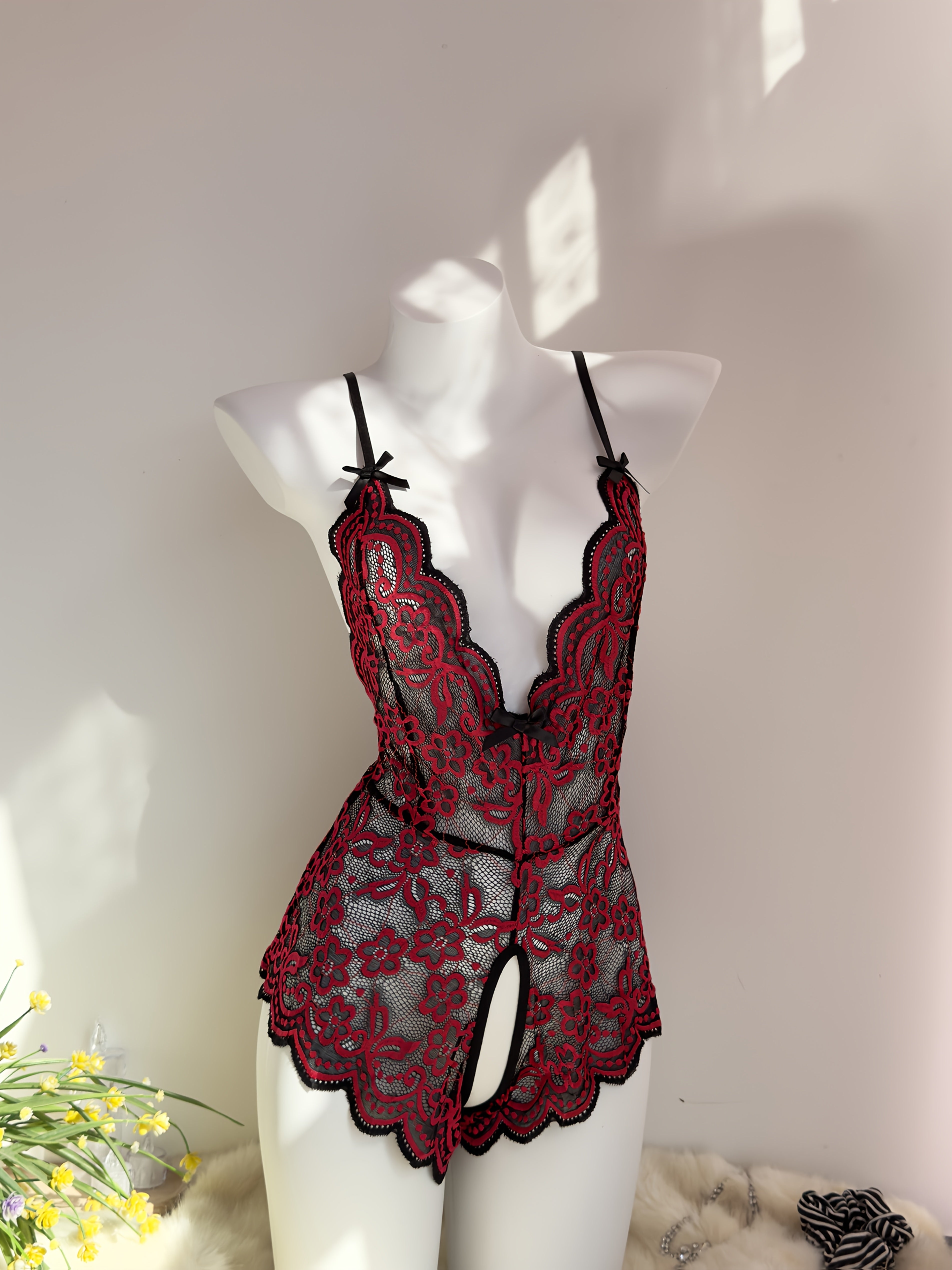 Jozibali dantel bodysuit, chuqur V-shakl, ochiq orqa va kesish tasma dizayni bilan.