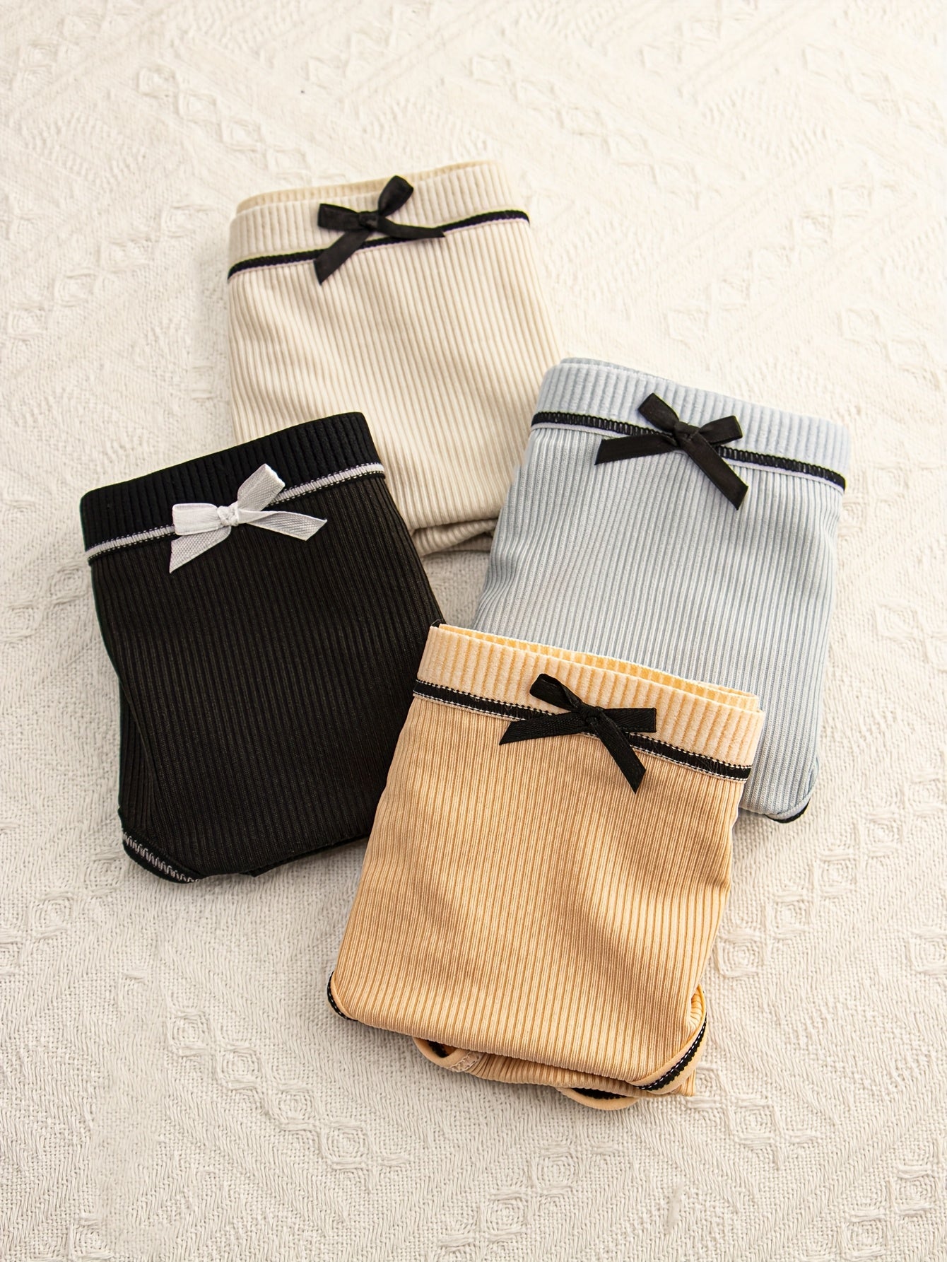 Pack de 4 braguitas de punto transpirable con ribete y diseño de triángulo para mujer