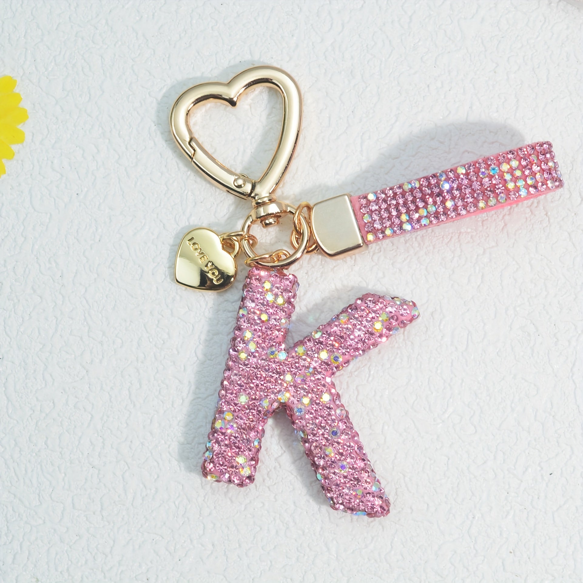 Llavero de PVC con iniciales de pedrería rosa y blanca con cierre de puño para mujeres