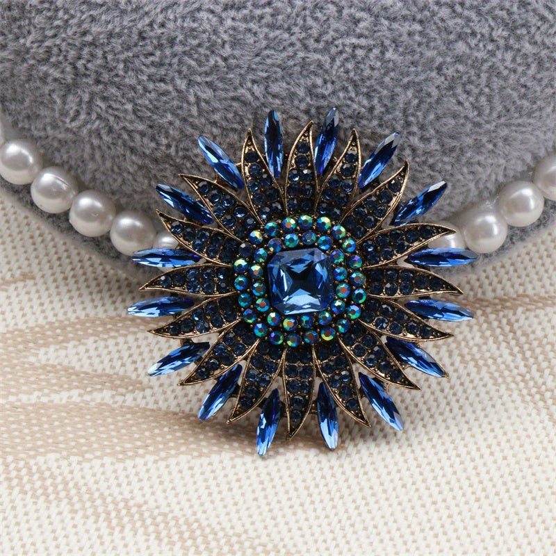 Bir nafis quyoshguli brosh, hashamatli kristal gullar bilan bezatilgan, o'ziga xos nishon, joziba va nafislikni tarqatadi. Do'stlar uchun mukammal aksessuar sovg'asi.