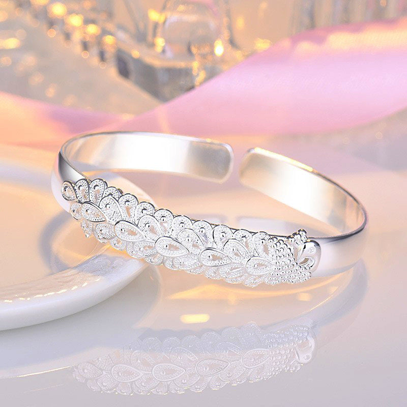 Women’s Ethnic-Inspired Bracelet with Peacock Feather Silk Opening and Phoenix Design