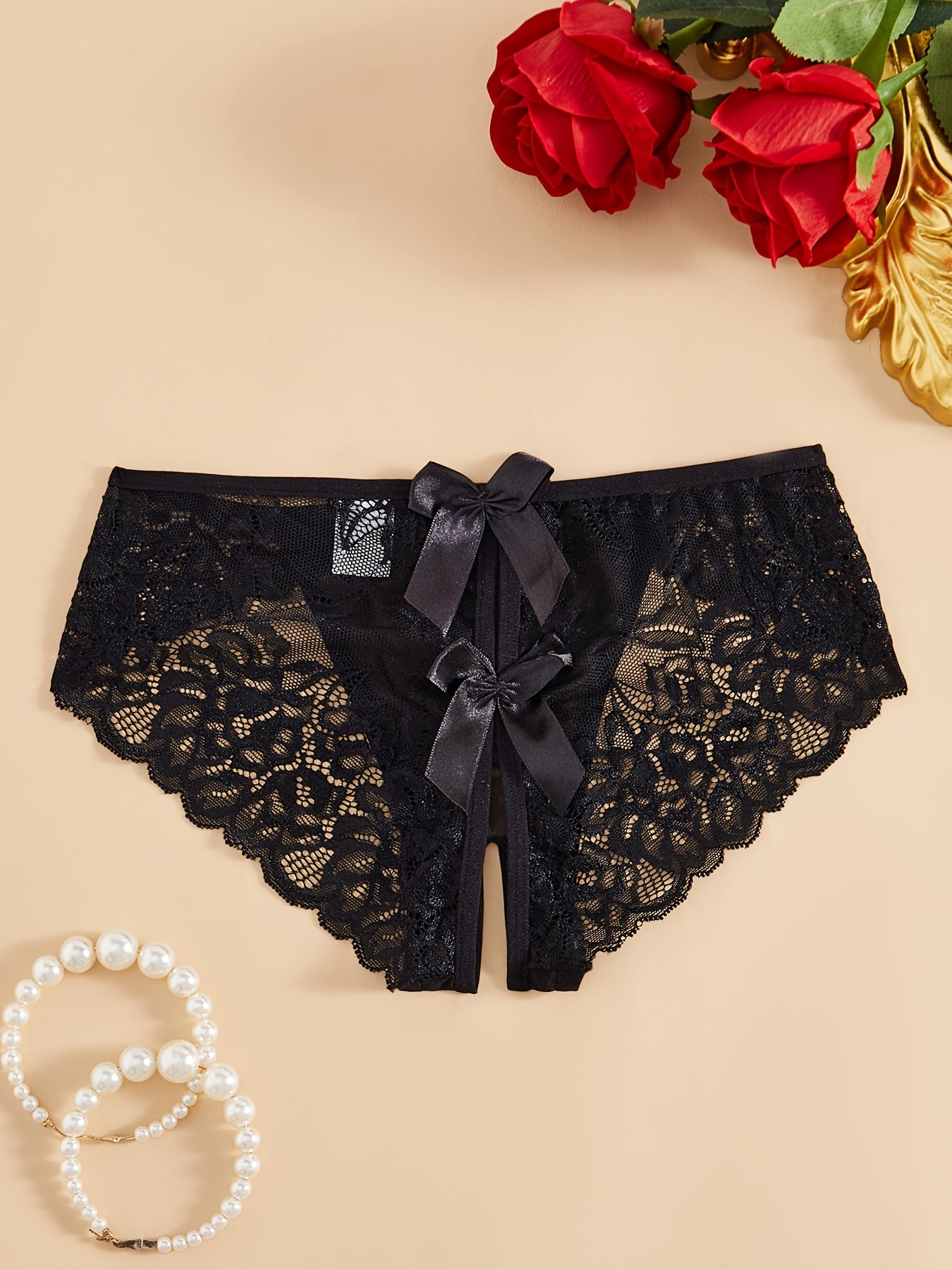 Трусики с низкой талией и украшением в виде банта, с открытым промежностью, из нейлона и полиэстера