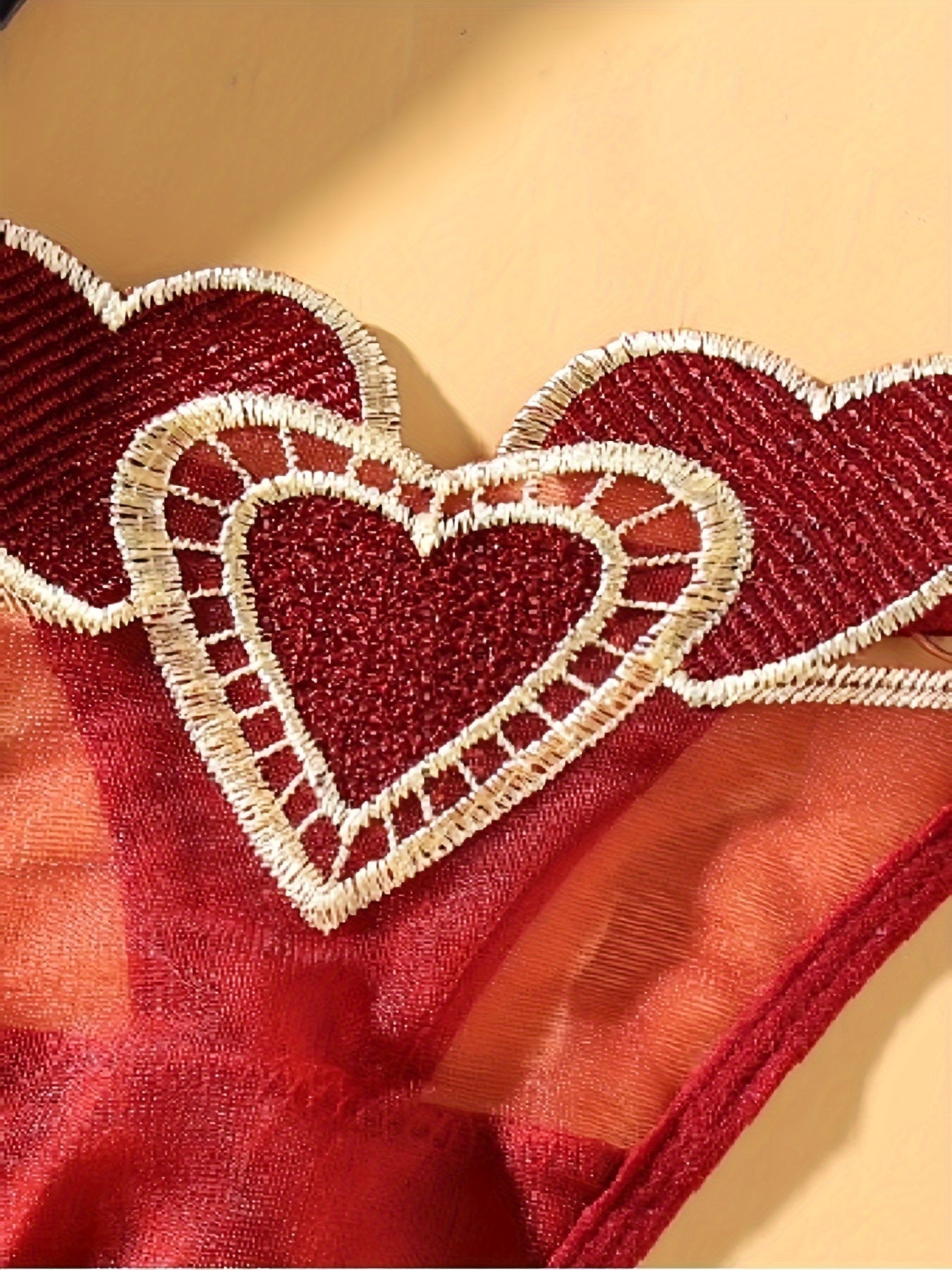 Ayollar uchun yurak naqshli thong ichki kiyim, moslashtiriladigan kattalashtirilgan o'lchamda, nafas oladigan to'r va jozibali to'qima bilan. Past bel, tungi klub uslubi, polyester materialda, S/M/L o'lchamlarida mavjud.