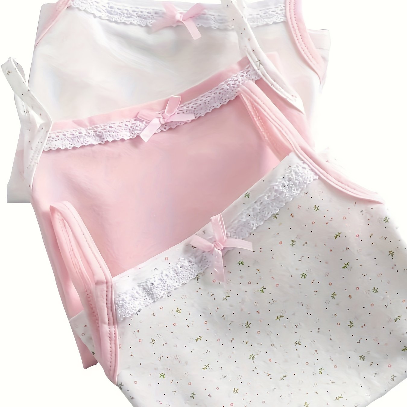 Qizlar uchun 3 ta sevimli bog‘ichli tank top to‘plami, nafas oladigan paxta matosi, yengsiz dizayni va gullar bosma bilan. Yil davomida kiyish uchun ideal.