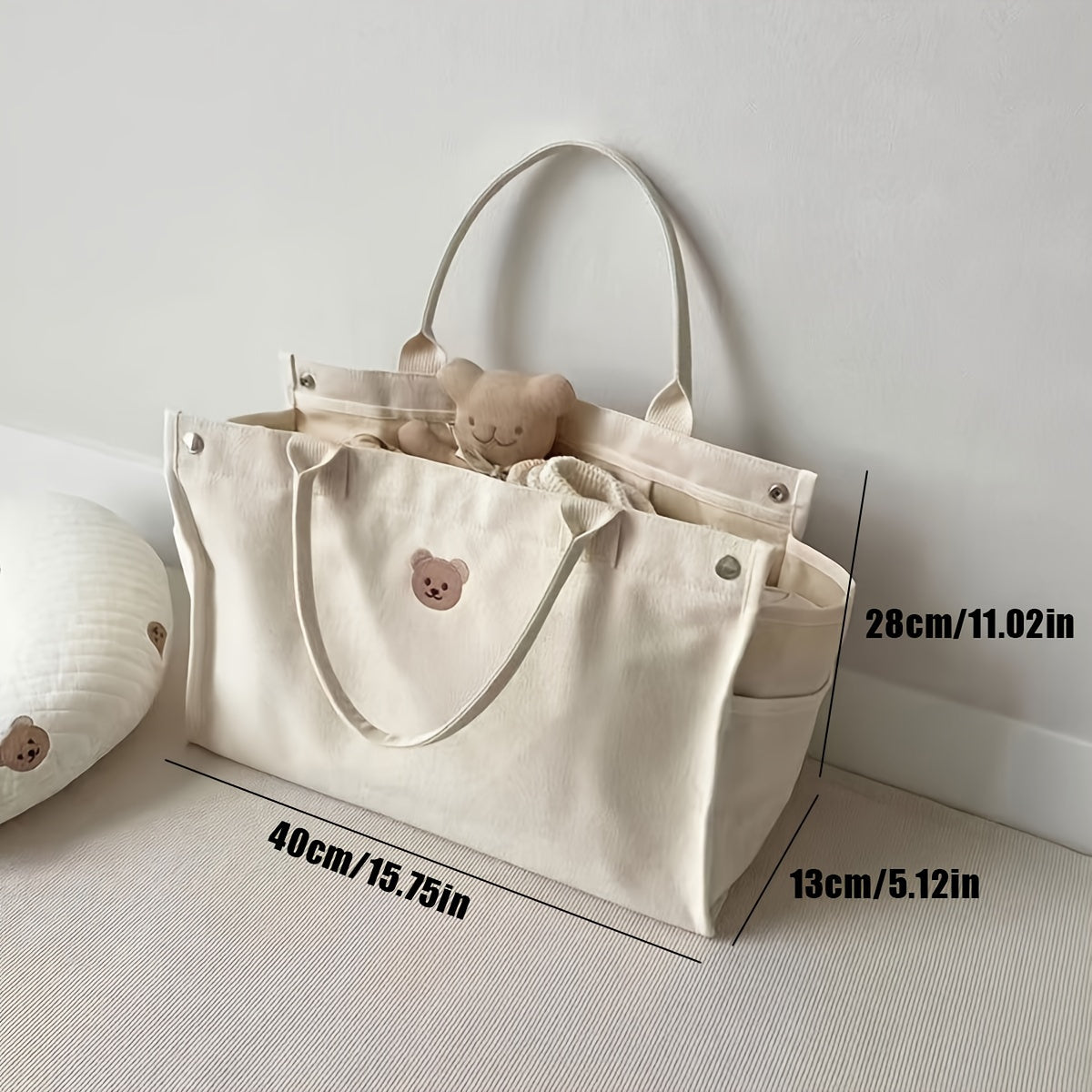 Zarif ayiq mavzusidagi to'plam sumkasi, mustahkam polyesterdan tayyorlangan, tozalash oson va oq rangda, pampers va kundalik zaruriy buyumlarni tashish uchun ideal.