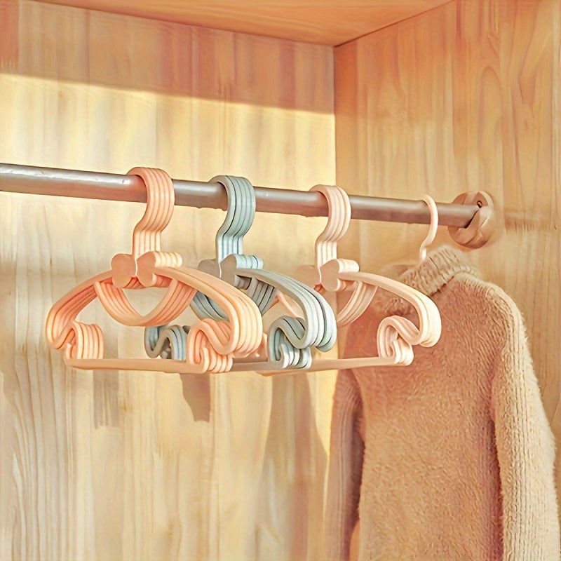 Juego de 10 perchas de plástico para niños con diseño de lazo para organización de guardería y armario
