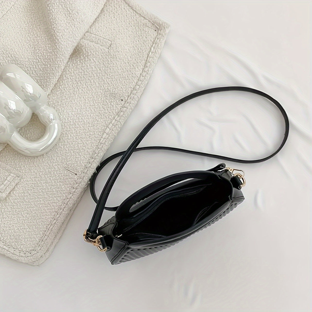 Black Crossbody Bag with Embossed Stripe Pattern and Gold Hardware for Women