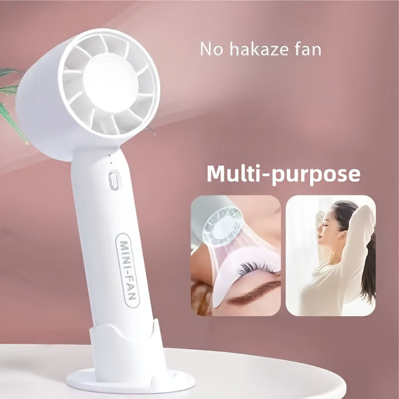 Portativ mini fan, USB bilan qayta zaryadlanadigan, 3 tezlik sozlamasi va asos standi bilan. Uy, ofis va ochiq sayohatlar uchun mos. Uchta rangda mavjud.