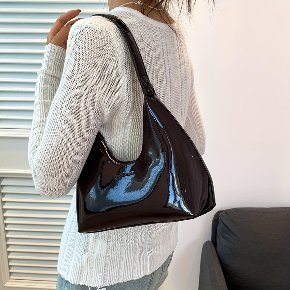 Шикарная красная сумка через плечо с глянцевой лакированной отделкой и застежкой на молнии, идеально подходящая для повседневного использования.