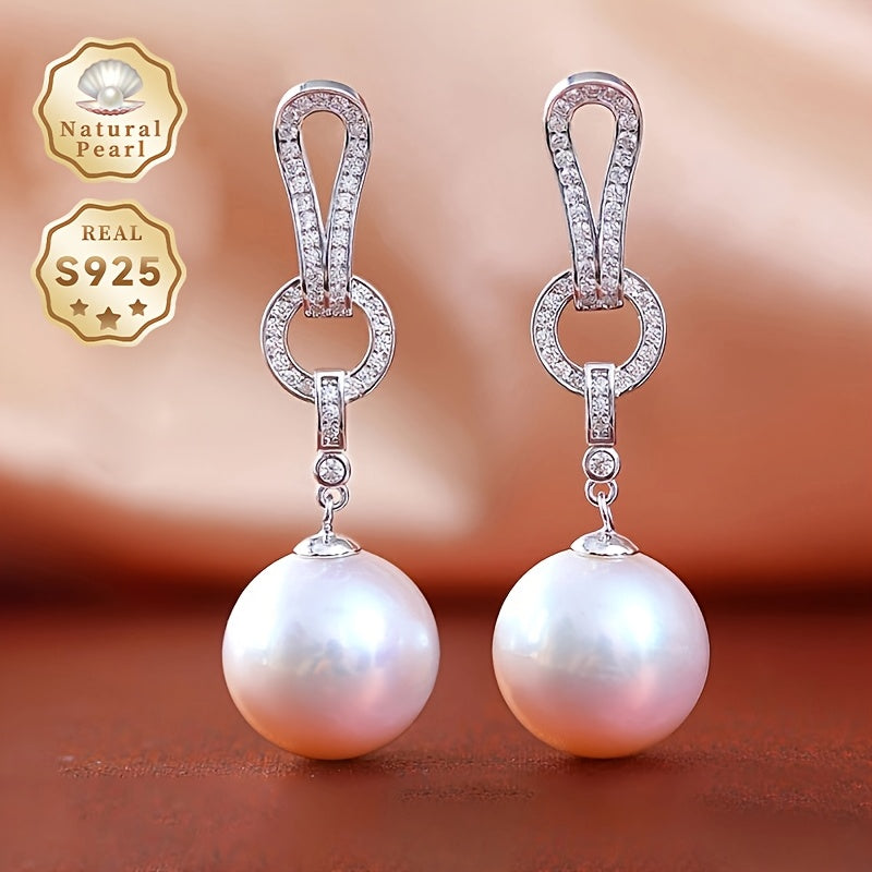 Kolleksiyangizga ushbu zarur Pearl Dangling Earrings bilan nafislik qo'shing. 13-14mm dumaloq tabiiy shirin suv marvaridlari bilan tayyorlangan, ushbu zamonaviy uzun sirg'alar S925 kumushdan yasalgan. Har bir juftlik noyob bo'lib, turli shakl va ...