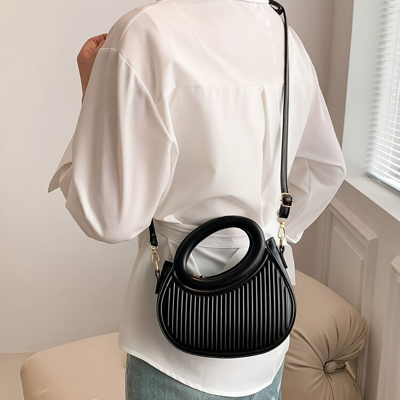 Black Crossbody Bag with Embossed Stripe Pattern and Gold Hardware for Women