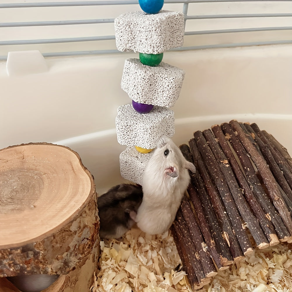 To‘g‘riqni maydalash toshi, qush qafasida gullar shaklida qo‘ng‘iroq bezakli mineral o‘yinchoq.