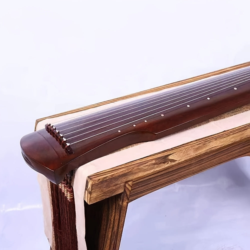 Guqin tradicional chino hecho de madera sólida de paulownia con acabado negro y clavijas de afinación doradas para principiantes